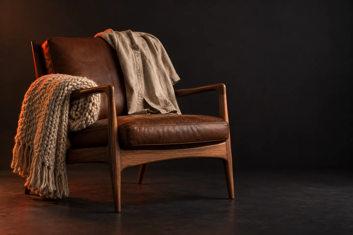Walnut lounge chair with a knit throw